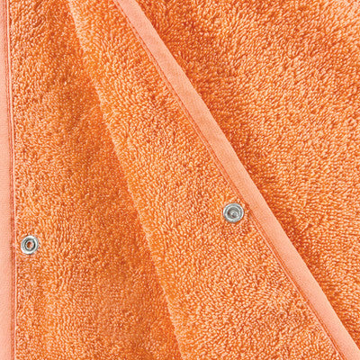 Detailansicht des Beach & Bandits Ponchos Papaya aus 100 % weicher Baumwolle in Orange. Nachhaltig und GOTS-zertifiziert.